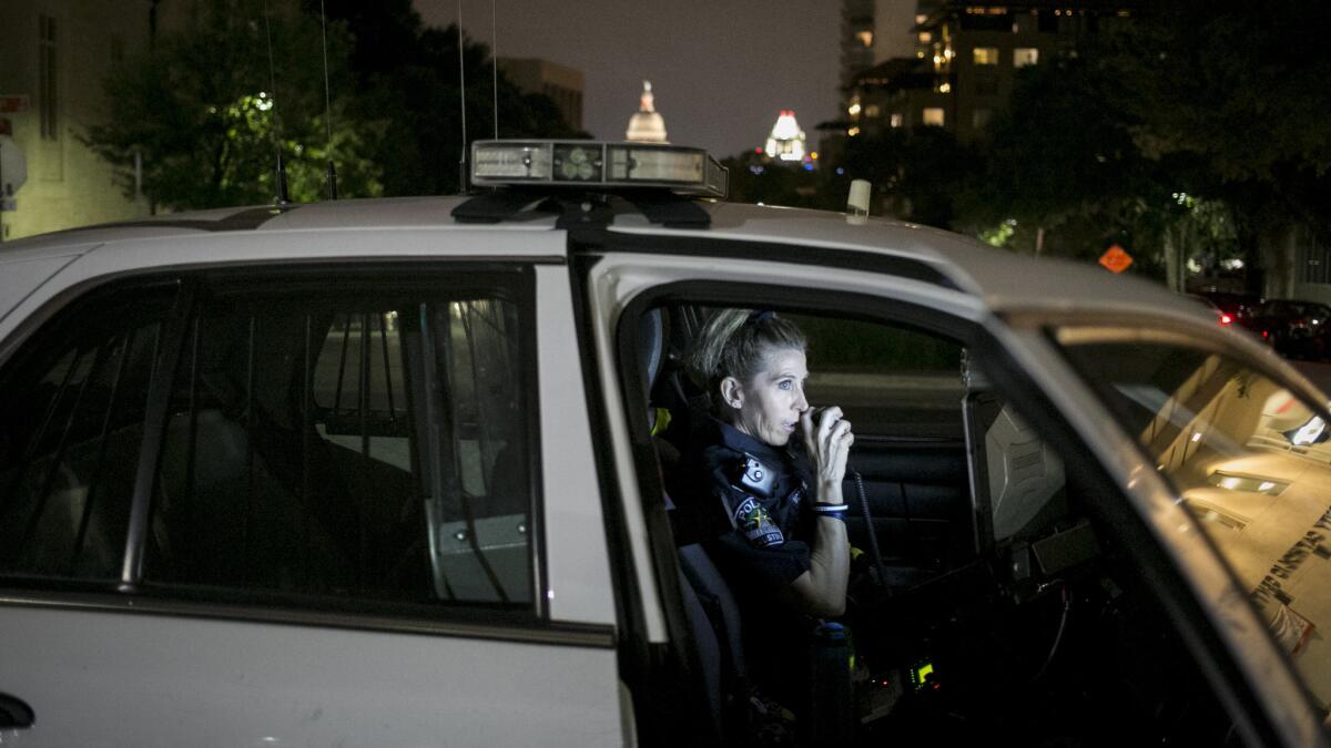 Austin police Officer Monika McCoy patrols her beat, which like her father's includes the area around the University of Texas tower,
