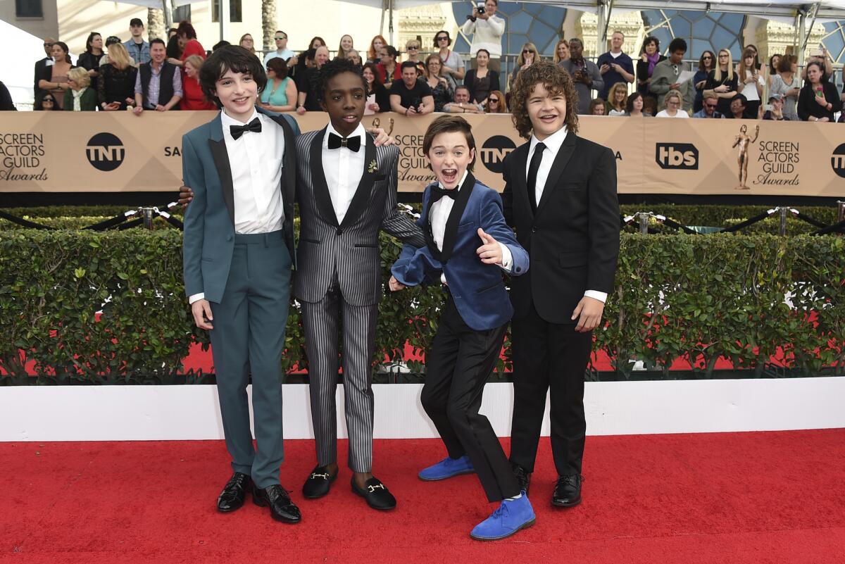 Finn Wolfhard, from left, Caleb McLaughlin, Noah Schnapp and Gaten Matarazzo arrive at the 23rd annual Screen Actors Guild Awards at the Shrine Auditorium & Expo Hall on Jan. 29 in Los Angeles.