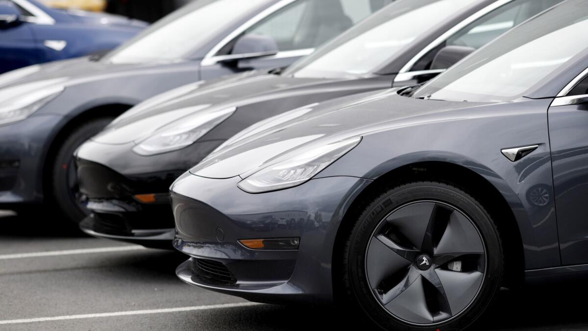 Unsold 2019 Model 3 sedans are lined up at a Tesla dealership in Littleton, Colo.