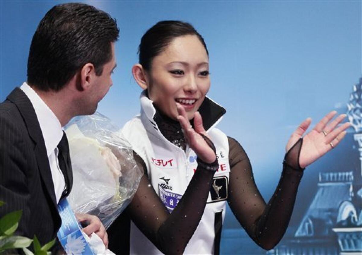 Japan's Miki Ando, right, and her coach Nikolai Morozov react after she performed her free program at the ISU Figure Skating World championships in Moscow, Russia, Saturday, April 30, 2011. (AP Photo/Dmitry Lovetsky)