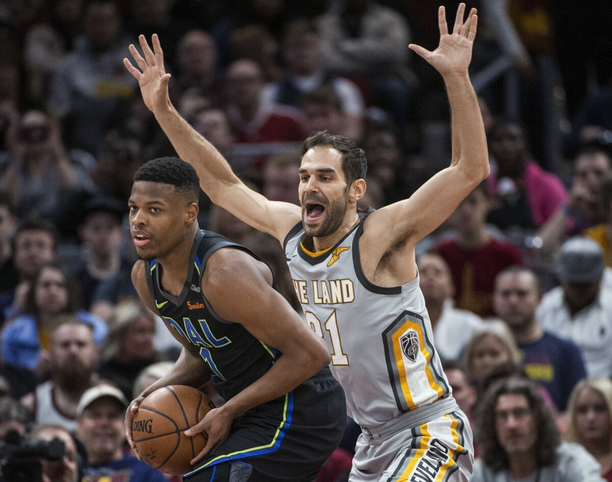 FILE - Cleveland Cavaliers' Jose Calderon (81) guards Dallas Mavericks' Dennis Smith Jr. (1) during the second half of an NBA basketball game in Cleveland, Sunday, April 1, 2018. The Cavaliers are bringing back former guard José Calderón as a special advisor in their front office. (AP Photo/Phil Long, File)
