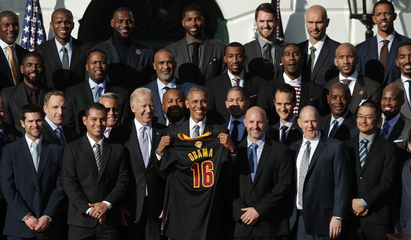 President Obama and Vice President Joe Biden pose for photos with members of the Cleveland Cavaliers during a South Lawn event on Thursday.