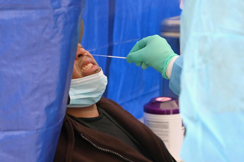 A healthcare worker takes a nasal swab sample to test for the coronavirus at the Brightpoint Health and UJA Federation for NY free pop-up coronavirus (COVID-19) testing site on May 8, 2020 in the Brooklyn borough of New York City. - The US Food and Drug Administration (FDA) on May 8, 2020 approved the first diagnostic test for coronavirus using saliva samples collected at home. (Photo by Angela Weiss / AFP) (Photo by ANGELA WEISS/AFP via Getty Images)