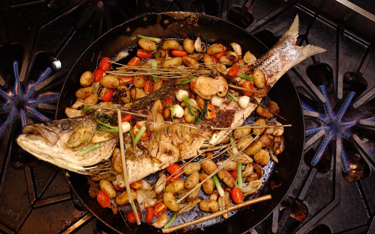 Whole baked fish with roasted vegetables