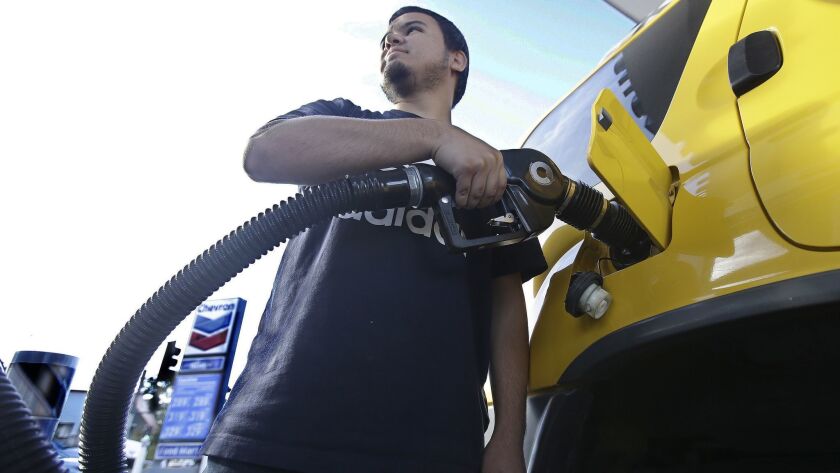 Cristian Rodriguez fuels his vehicle in Sacramento as battle lines are being drawn over a proposal to repeal an increase in the state's gas tax and vehicle fees.