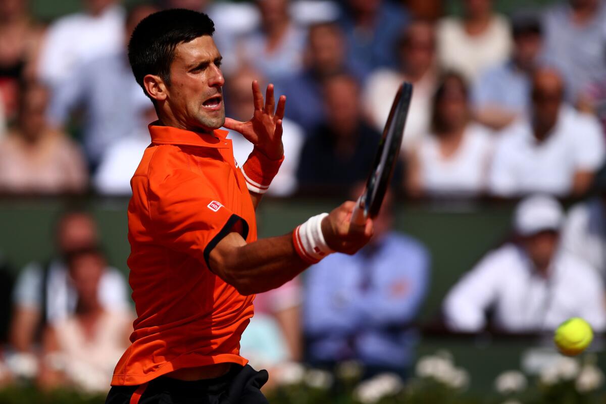 Novak Djokovic returns a shot against Rafael Nadal during their French Open quarterfinal match on Wednesday in Paris.