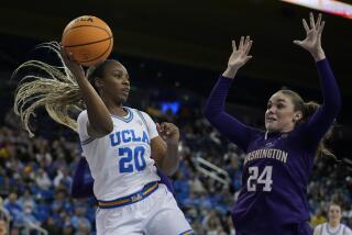 UCLA guard Charisma Osborne (20) passes against Washington guard Elle Ladine.