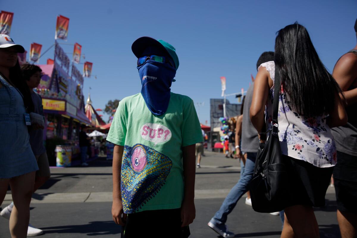 A boy wears a mask to prevent sunburn at the Orange County Fair in 2019