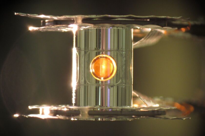An image of the tiny gold can (known as the hohlraum) with a cutaway showing a fuel capsule inside. Scientists at Lawrence Livermore National Laboratory conducting laser-based nuclear fusion experiments have seen more energy come out of their deuterium-tritium fuel than was put in, they report in Nature.