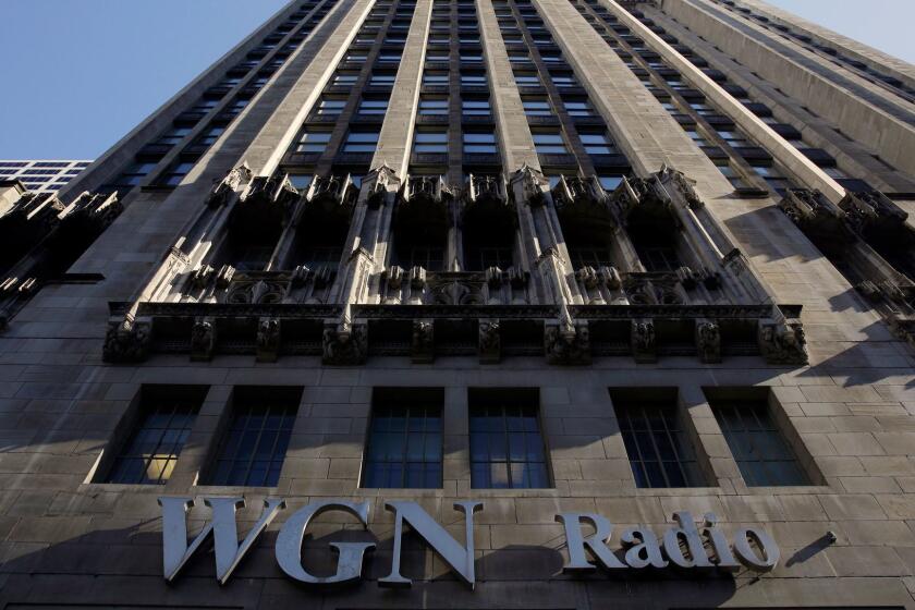 The WGN Radio sign appears on the side of Tribune Tower, Monday, May 1, 2017, in downtown Chicago. TV station operator Tribune Media is at the center of a possible bidding war, following reports that Fox News owner 21st Century Fox and investment firm Blackstone may make a joint takeover bid for the company. Tribune owns or operates 42 local TV stations across the nation, including WPIX in New York, KTLA in Los Angeles and WGN in Chicago. (AP Photo/Kiichiro Sato)