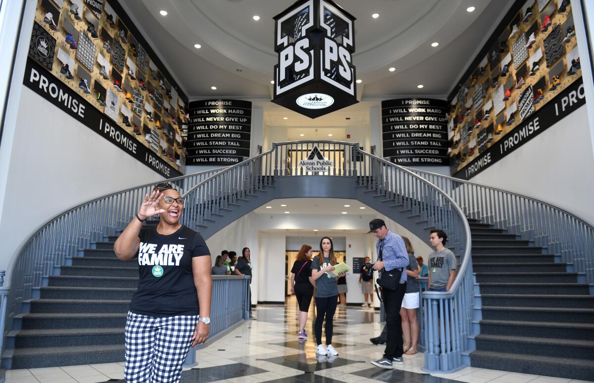 Principal Brandi Davis waves in the lobby of the I Promise School. “We are going to be that groundbreaking school that will be a nationally recognized model for urban and public school excellence,” she said.