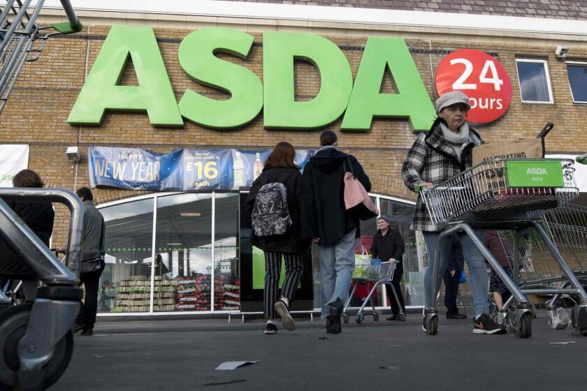 (FILES) In this file photo taken on January 10, 2018 customers come and go at a branch of Asda supermarket in south London. Britain's second and third biggest supermarket chains, Sainsbury's and Walmart-owned rival Asda, have agreed terms for a merger that will create a new retail giant, the pair announced on April 30, 2018. / AFP PHOTO / Justin TALLISJUSTIN TALLIS/AFP/Getty Images ** OUTS - ELSENT, FPG, CM - OUTS * NM, PH, VA if sourced by CT, LA or MoD **