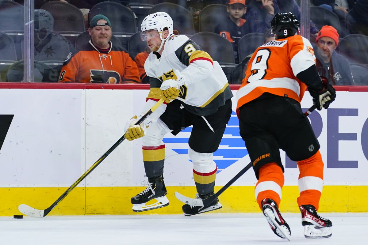 Vegas Golden Knights' Jack Eichel, left, skates past Philadelphia Flyers' Ivan Provorov during the third period of an NHL hockey game, Tuesday, March 8, 2022, in Philadelphia. (AP Photo/Matt Slocum)