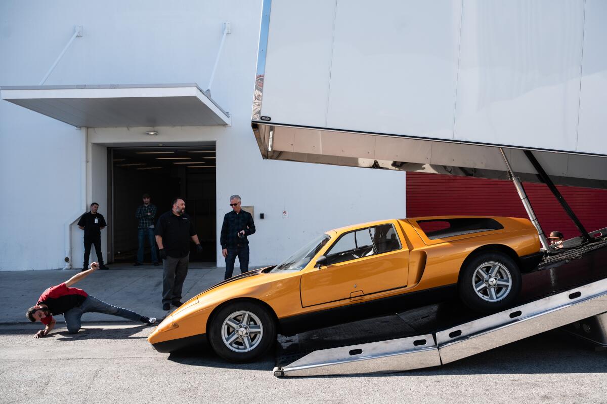 The 1970 Mercedes-Benz Type C 111-II is backed up a ramp, with little ground clearance to spare, onto a truck headed to LAX 