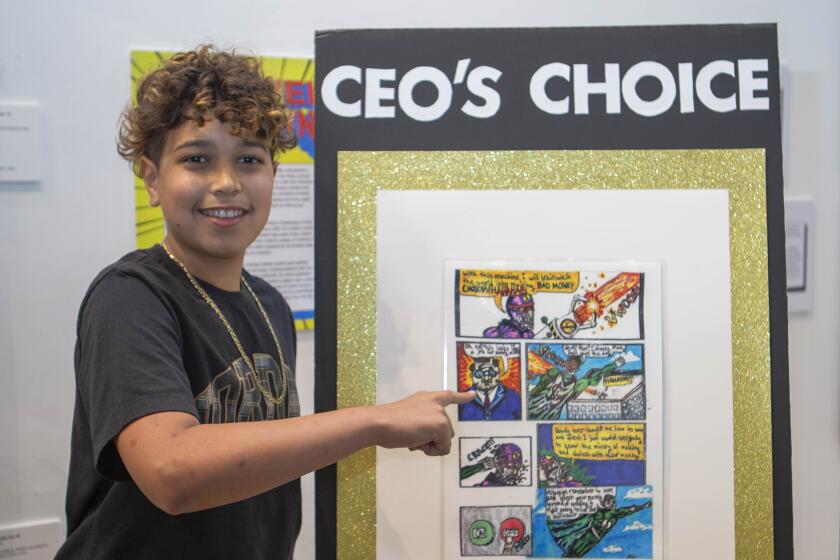 Diego Sopielnikow shows his comic that won the CEO'S Choice Award in the Financial Literacy Superheroes Competition.