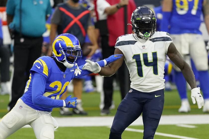 Seattle Seahawks wide receiver DK Metcalf (14) is defended by Los Angeles Rams cornerback Jalen Ramsey (20) during the second half of an NFL football game Sunday, Nov. 15, 2020, in Inglewood, Calif. (AP Photo/Ashley Landis)