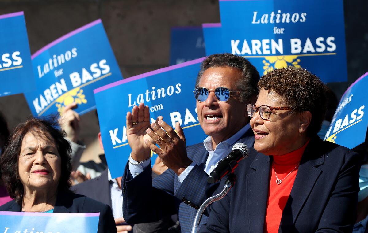 Dolores Huerta and former Mayor Antonio Villaraigosa cheer Rep. Karen Bass at a campaign event.
