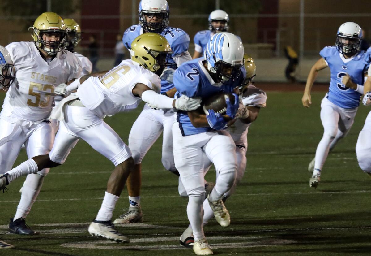 Crescenta Valley's Maximus Grant breaks away Muir's defense during Crescenta Valley High School varsity football team against John Muir High School's varsity football team at Glendale High School football stadium in Glendale, Ca., Friday, October 25, 2019. (photo by James Carbone)