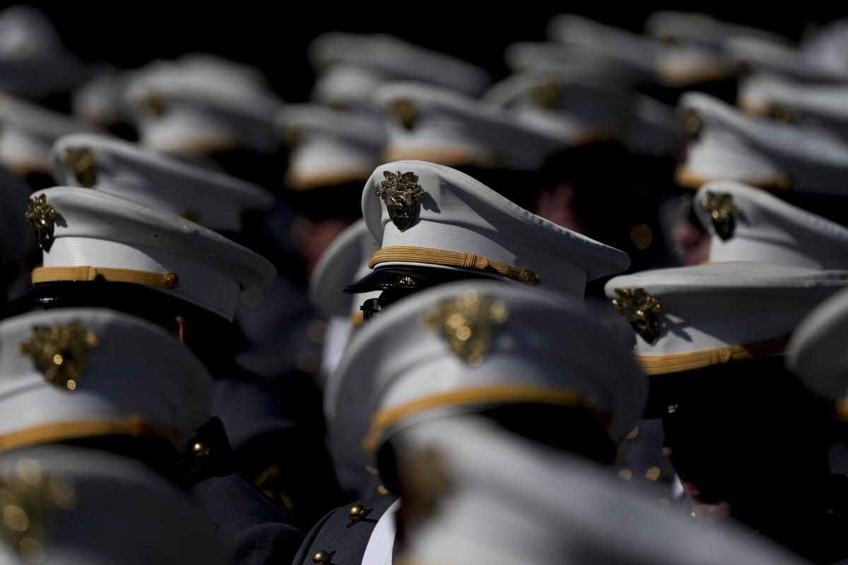 A group of U.S. Military Academy cadets with their insignia hats visible