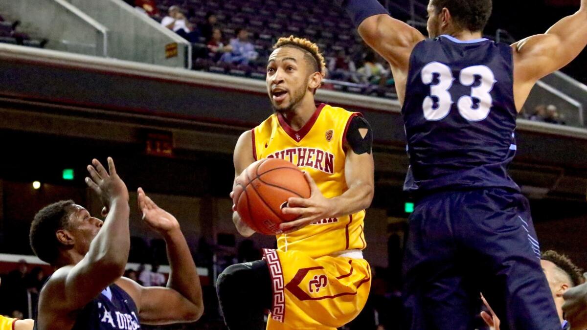 USC point guard Jordan McLaughlin slashes through the lane between two San Diego defenders in the Trojans' 83-45 win.
