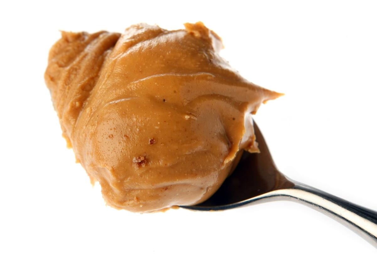 Some almond butters have been recalled from Whole Foods and Trader Joe's stores. The nut butters are part of a larger recall affecting certain peanut butters as well. Picture is a spoonful of peanut butter.