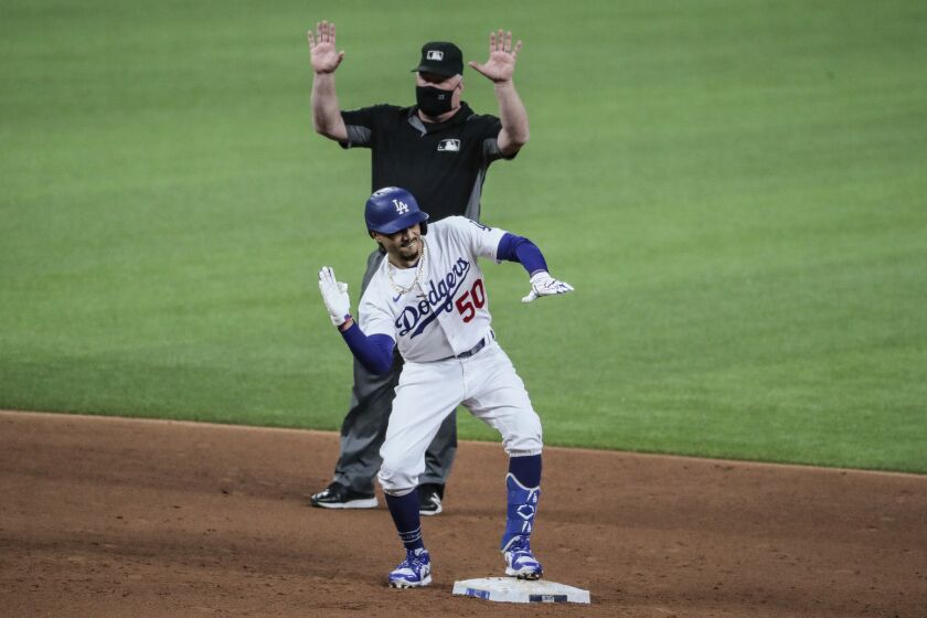 Arlington, Texas, Tuesday, October 6, 2020. Los Angeles Dodgers right fielder Mookie Betts (50) makes a chopping gesture after doubling in the sixth inning in game one of the NLDS at Globe Life Field. (Robert Gauthier/ Los Angeles Times)