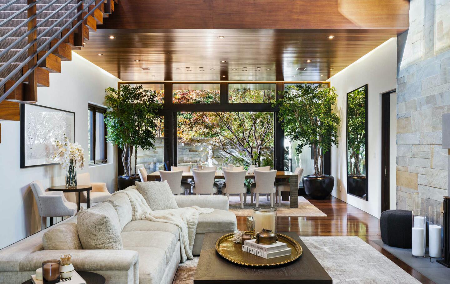 The furnished living room with big windows.