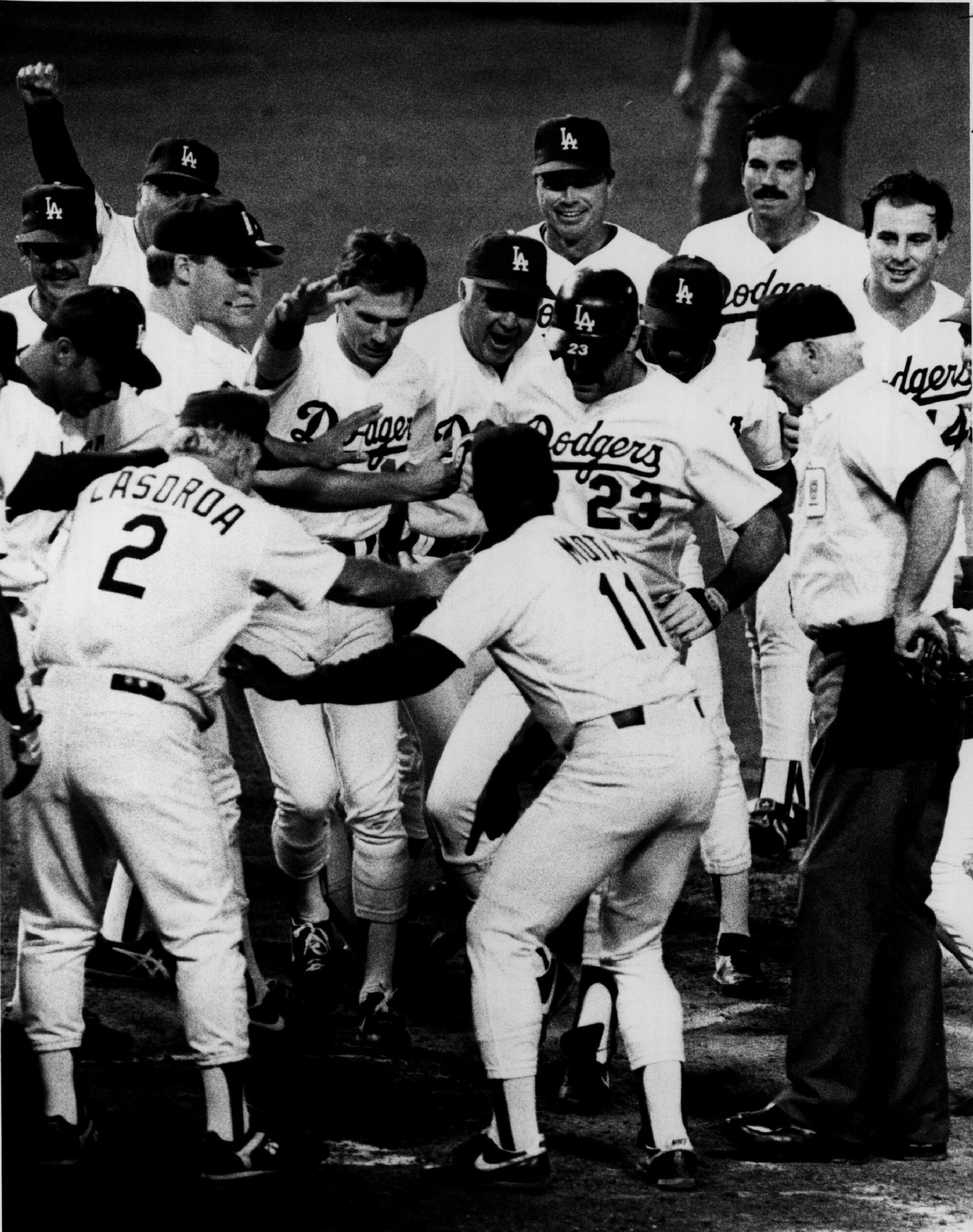 Tommy Lasorda (2) and the Dodgers mob Kirk Gibson (23) after Gibson's walk-off home run in Game 1 of the 1988 World Series.