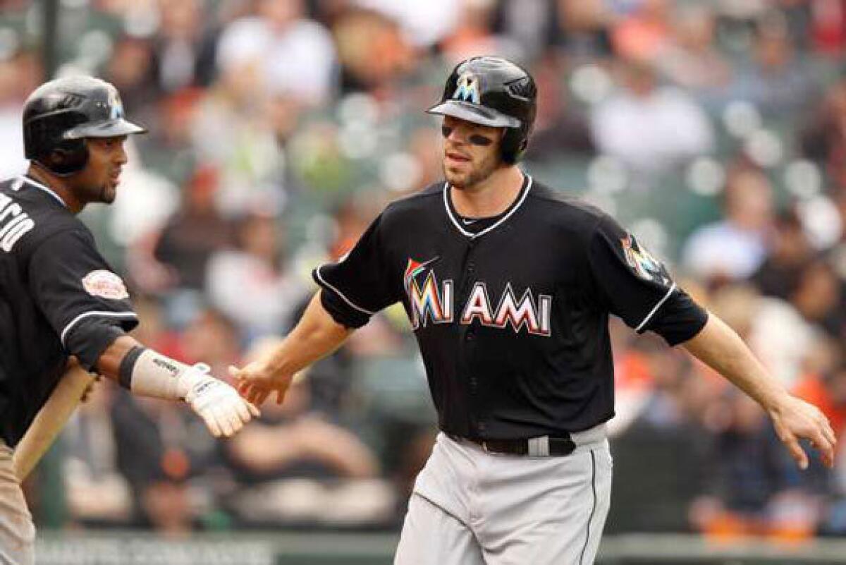 Marlins catcher Brett Hayes is congratulated by Emilio Bonifacio after he scored in the eighth inning against the San Francisco Giants on May 3.