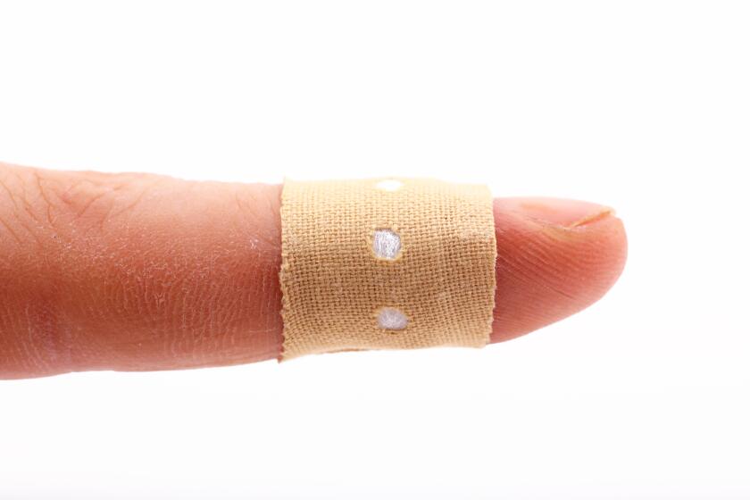 Human finger with bandage