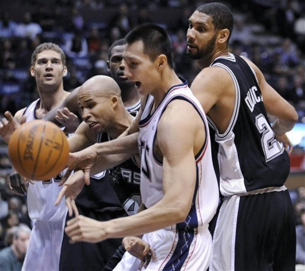 Yi Jianlian and Brook Lopez of the New Jersey Nets look on during