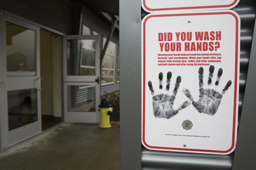 A sign reminding people to wash their hands is pictured outside a dormitory at the Washington State Patrol Fire Training Academy which has been designated as a 2019 novel coronavirus quarantine site for travelers from Hubei Province, China who have been exposed, are not yet symptomatic and cannot self-quarantine, February 6, 2020 in North Bend, Washington. - The Washington State Patrol Fire Training Academy near North Bend has been chosen as a new quarantine site for people returning to the United States from the Chinese province at the center of the new coronavirus outbreak. (Photo by Jason Redmond / AFP) (Photo by JASON REDMOND/AFP via Getty Images)