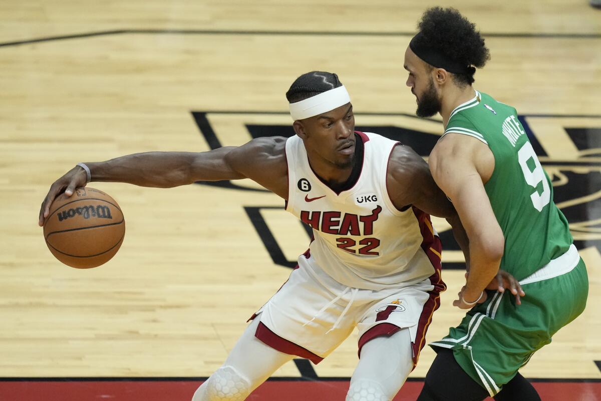 The Heat's Jimmy Butler handles the ball against the Celtics' Derrick White on May 27, 2023.