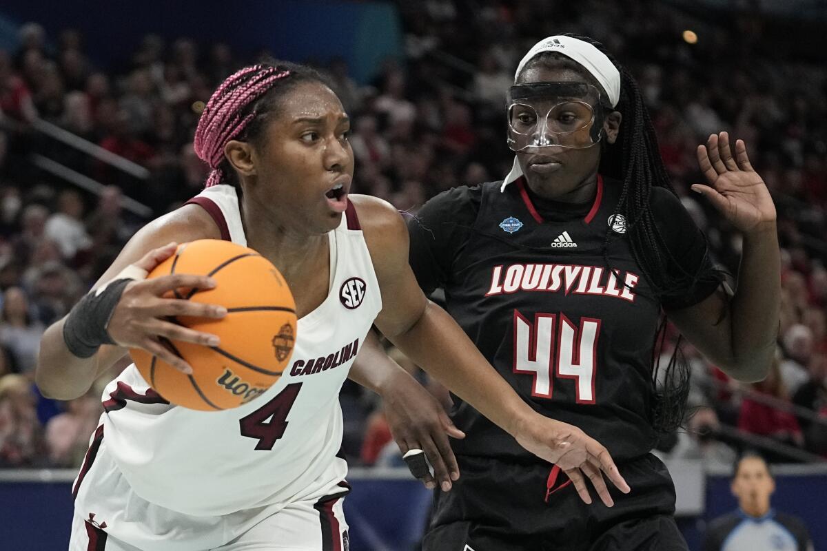 South Carolina's Aliyah Boston, who had 23 points and 18 rebounds, drives past Louisville's Olivia Cochran.