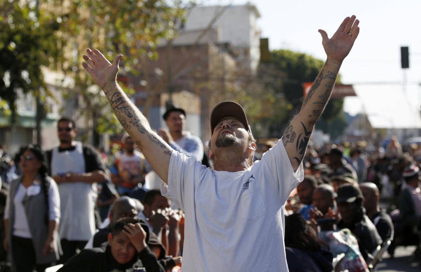 Lee Hunt prays before being served dinner on Thanksgiving in Los Angeles. The Fred Jordan Mission held its annual Thanksgiving banquet for homeless men and women who live on skid row.