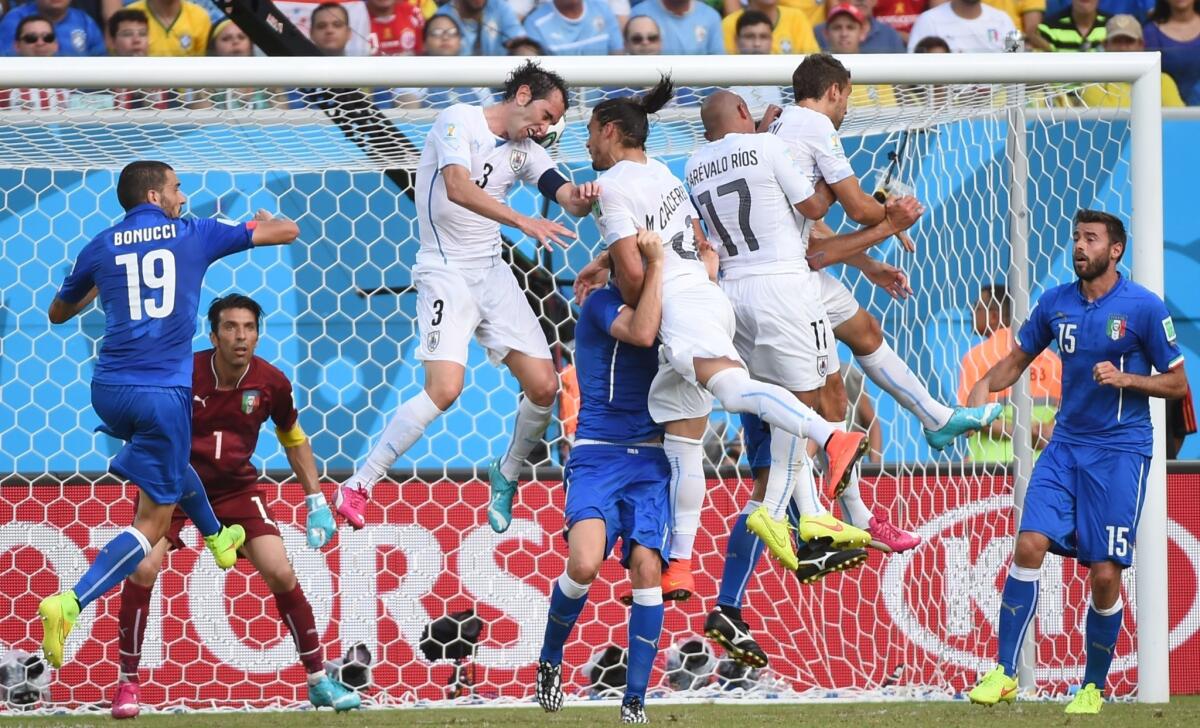 Uruguay's Diego Godin (3) knocks the ball in during the 81st minute for a 1-0 victory over Italy on Tuesday.