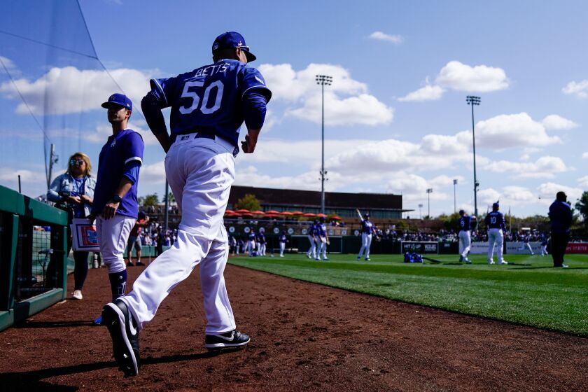 PHOENIX, ARIZ. - FEBRUARY 23: Los Angeles Dodgers Mookie Betts (50) takes to the field before the start of a Spring Training game between the Los Angeles Dodgers and the Chicago Cubs at Camelback Ranch on Sunday, Feb. 23, 2020 in Phoenix, Ariz. (Kent Nishimura / Los Angeles Times)