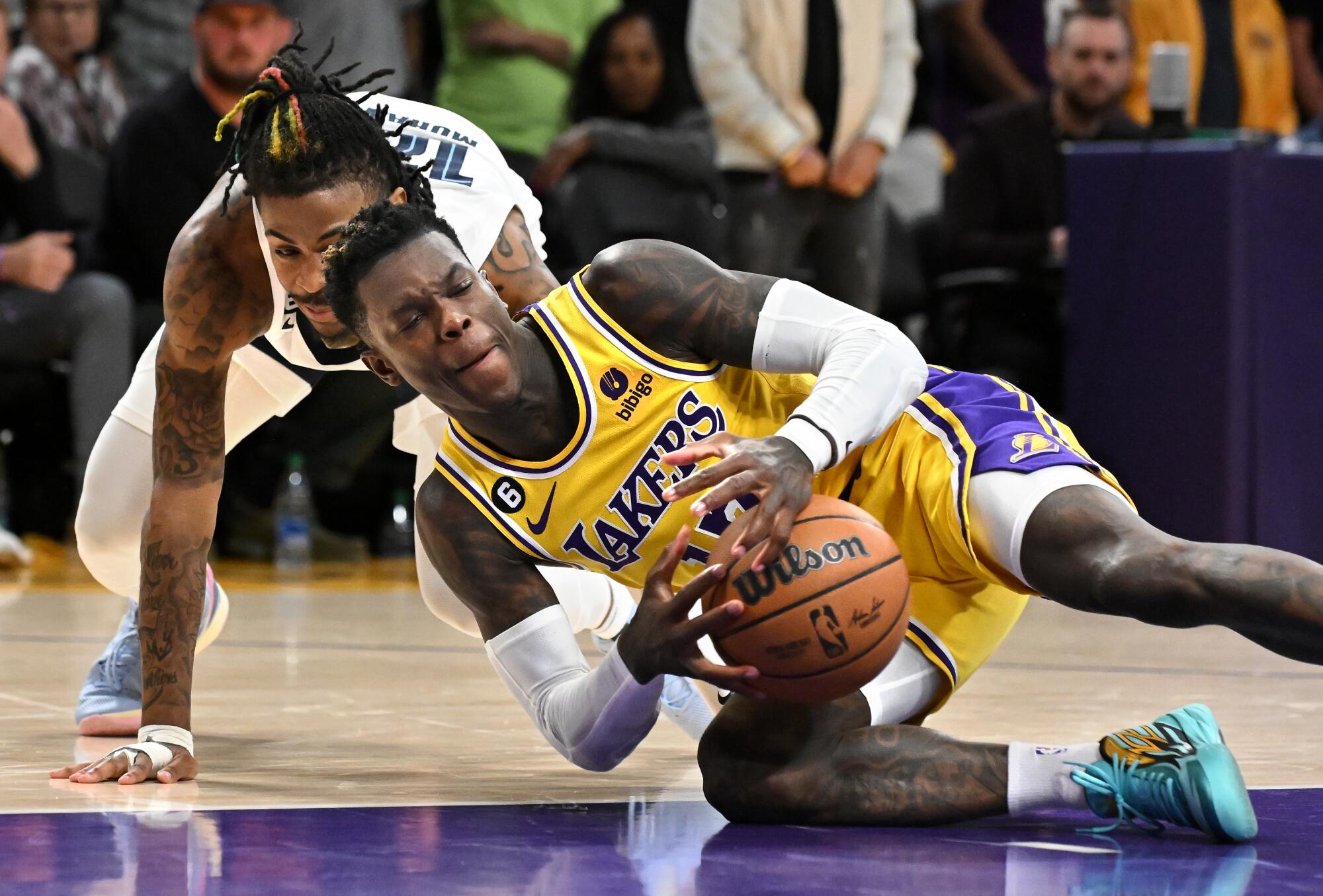 Lakers Dennis Schroder grabs a loose ball from Grizzlies Ja Morant in overtime.