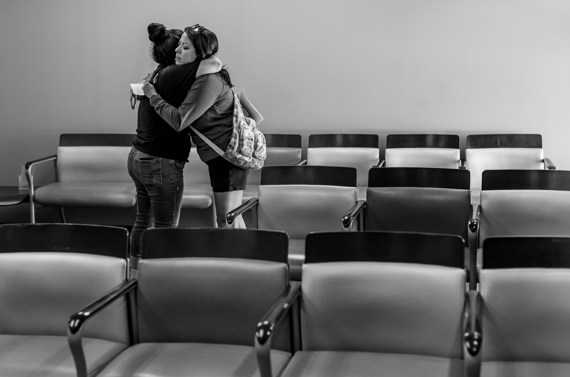 A teary staff member hugs a patient April Reese,41, after informing her the clinic could no longer provide abortion services 