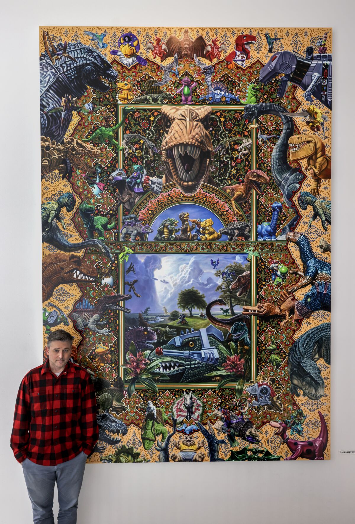 Artist Robert Xavier Burden with his painting "Dinosaur Toys" at the Oceanside Museum of Art.  