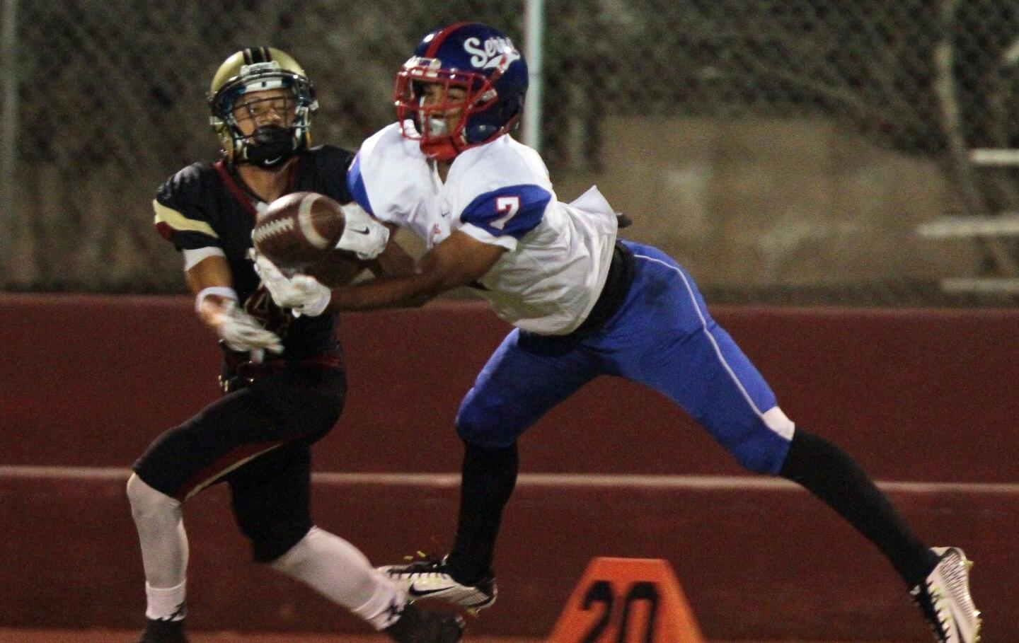 Gardena Serra's Brandon Burton, right, breaks up a pass intended for Alemany receiver Stanley Norman during a game Friday in Mission Hills, Calif.