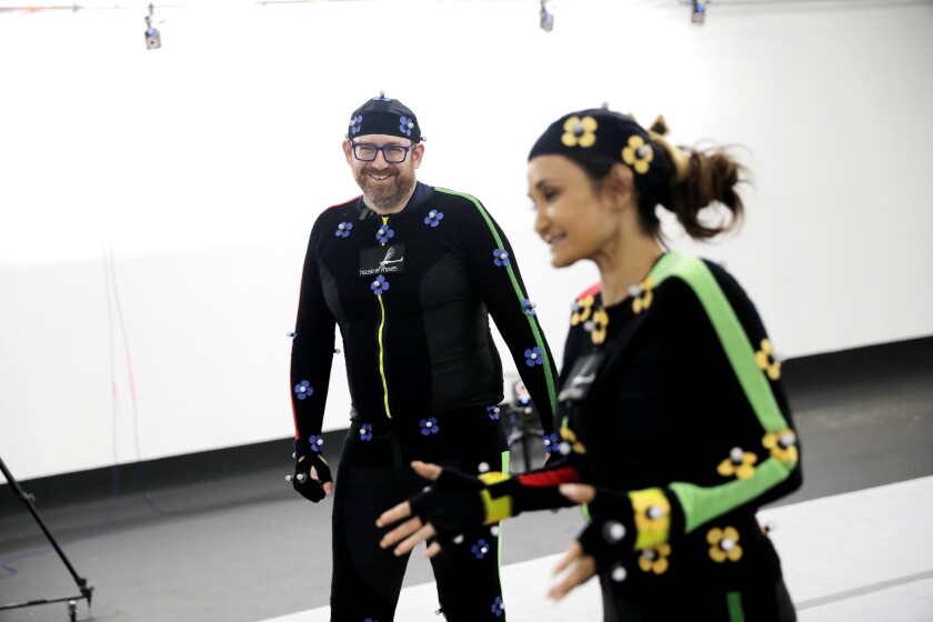 A man and a woman in motion capture gear