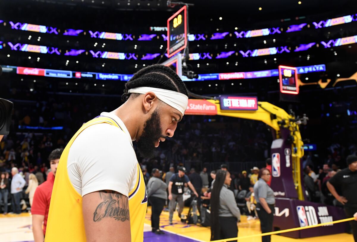 Lakers forward Anthony Davis walks off the court after a season-ending loss to the Denver Nuggets.