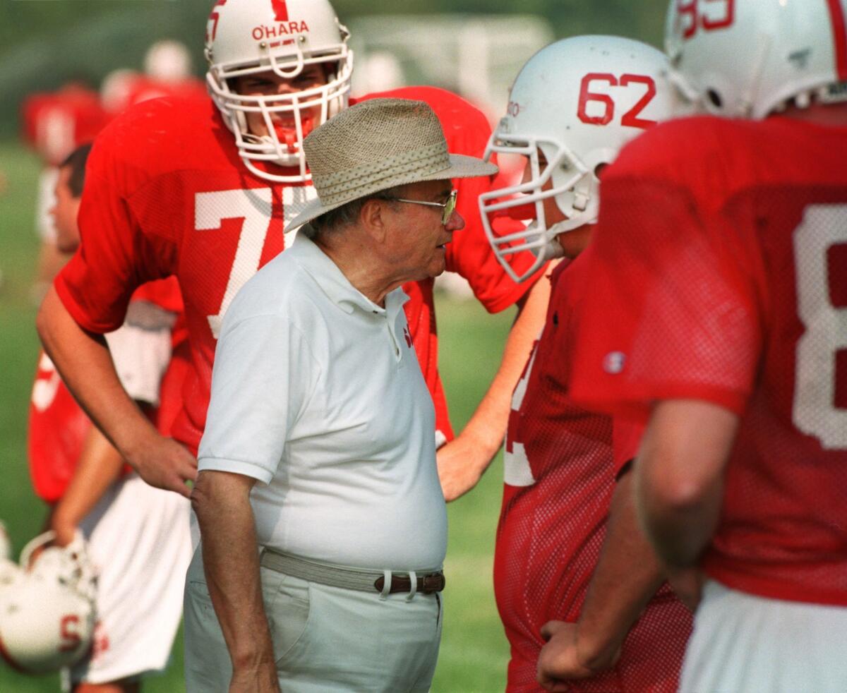 John Gagliardi talks to player Andy Gregory during a 1998 practice.