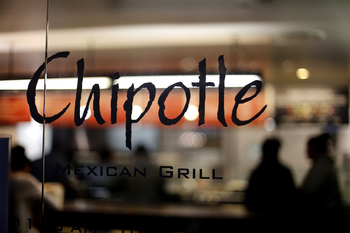 A Chipotle sign on the window of a restaurant in Union Station in Washington. 