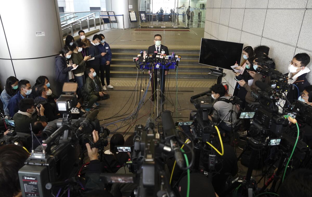 Li Kwai-wah, center, senior superintendent of National Security Department talks to reporters in Hong Kong. 