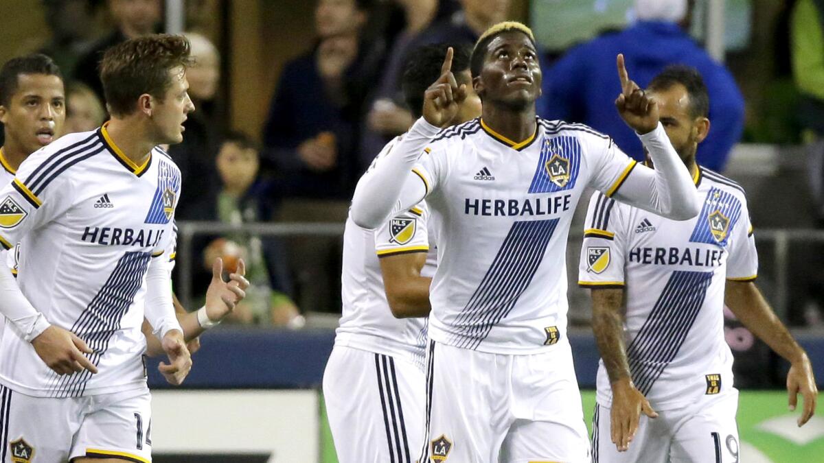 Galaxy forward Gyasi Zardes celebrates with teammates after he scored a goal against the Sounders in the first half Wednesday night in Seattle.
