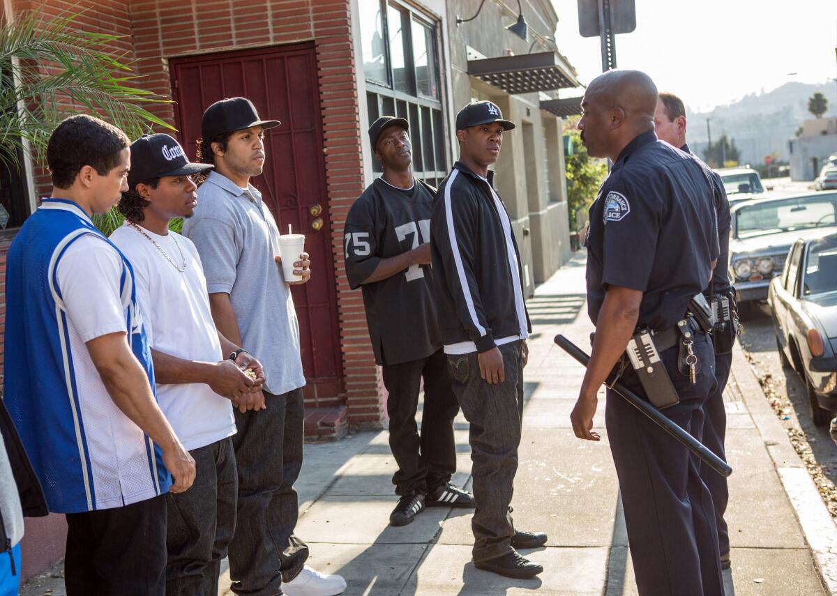 Neil Brown, Jr., from left, as DJ Yella, Jason Mitchell as Eazy-E, O’Shea Jackson Jr. as Ice Cube, Aldis Hodge as MC Ren and Corey Hawkins as Dr. Dre, with police in “Straight Outta Compton."