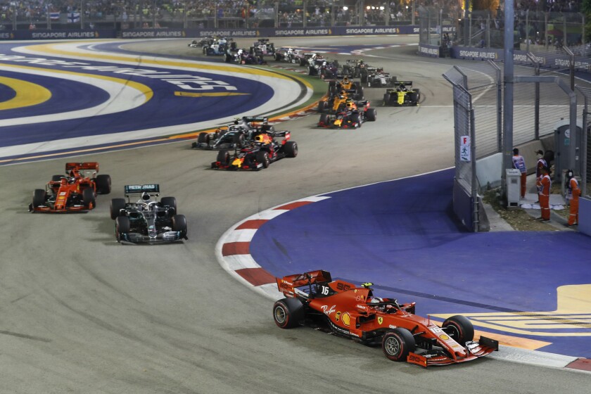 FILE - Ferrari driver Charles Leclerc of Monaco leads the field at the start of the Singapore Formula One Grand Prix, at the Marina Bay City Circuit in Singapore, Sunday, Sept. 22, 2019. Formula One signed a seven-year contract extension Thursday, Jan. 27, 2022 with the Singapore Grand Prix. F1 said in a statement that a deal to continue racing at the Marina Bay street circuit until 2028 was agreed with the Singapore GP and Singapore's tourism board. (AP Photo/Vincent Thian, File)