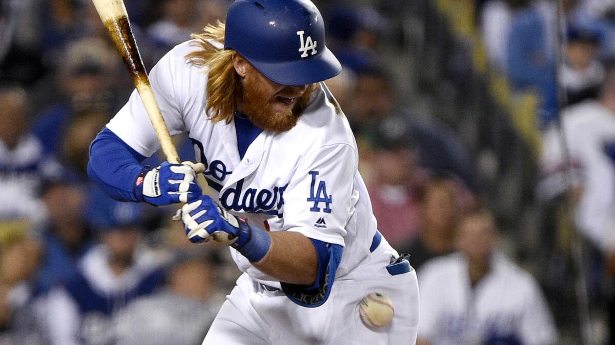 Dodgers third baseman Justin Turner is hit by a pitch while batting against the Diamondbacks on Wednesday.